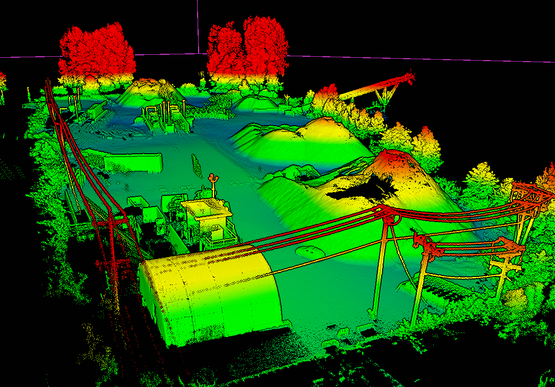 LiDAR point cloud of a working stockpile yard, coloured by elevation, with individual piles and site structures clearly resolved